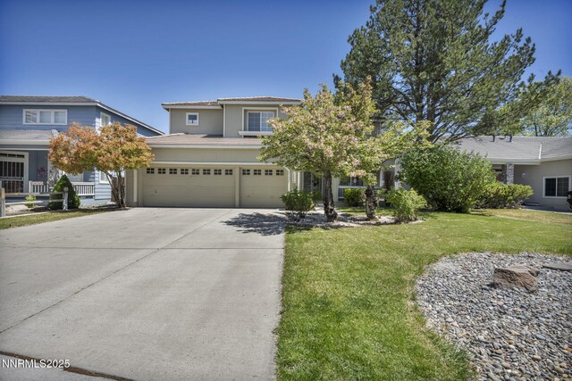 3250 Eaglewood Dr, Reno, NV 89502 - view of front facade with concrete driveway, a front lawn, an attached garage, and a tiled roof