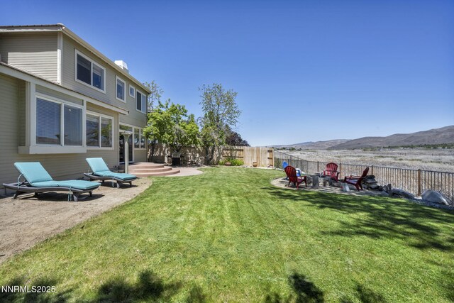 3250 Eaglewood Dr, Reno, NV 89502 - view of yard featuring a mountain view, a patio area, and a fire pit