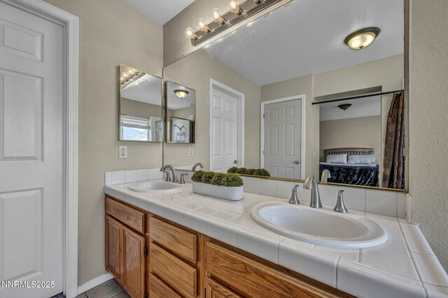 3250 Eaglewood Dr, Reno, NV 89502 - ensuite bathroom featuring double vanity and a textured wall