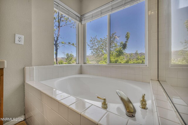 3250 Eaglewood Dr, Reno, NV 89502 - full bathroom with plenty of natural light, a bath, and a textured wall