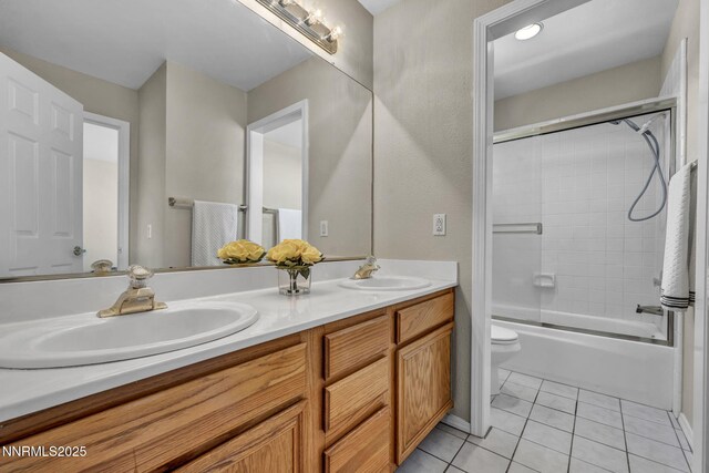 3250 Eaglewood Dr, Reno, NV 89502 - bathroom with double vanity, toilet, tile patterned floors, and combined bath / shower with glass door