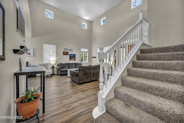 3250 Eaglewood Dr, Reno, NV 89502 - staircase featuring wood finished floors and a high ceiling