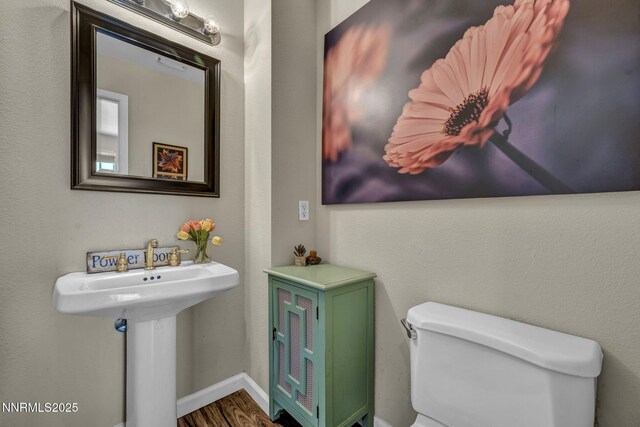 3250 Eaglewood Dr, Reno, NV 89502 - bathroom with toilet, wood finished floors, and baseboards