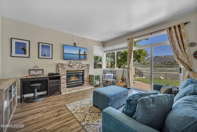 3250 Eaglewood Dr, Reno, NV 89502 - living room with wood finished floors, a fireplace, and baseboards