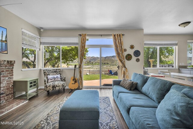 3250 Eaglewood Dr, Reno, NV 89502 - living room with a mountain view, wood finished floors, and baseboards