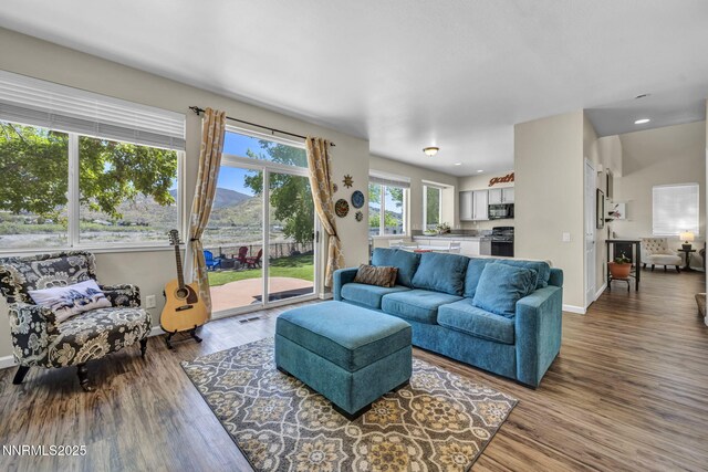 3250 Eaglewood Dr, Reno, NV 89502 - living room with wood finished floors, baseboards, recessed lighting, and a mountain view