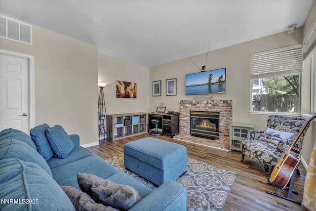 3250 Eaglewood Dr, Reno, NV 89502 - living room with wood finished floors, baseboards, and a brick fireplace