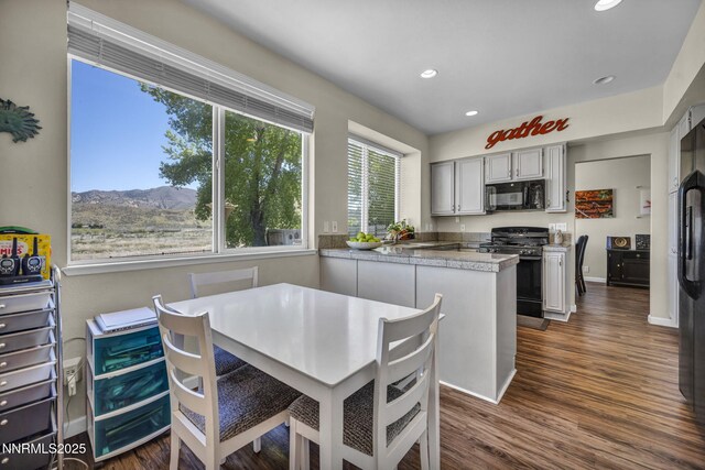 3250 Eaglewood Dr, Reno, NV 89502 - dining room featuring recessed lighting, dark wood finished floors, a mountain view, and baseboards