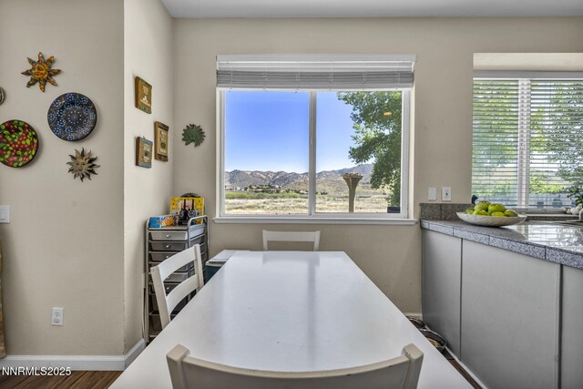 3250 Eaglewood Dr, Reno, NV 89502 - dining area with healthy amount of natural light, baseboards, and wood finished floors
