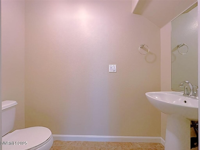 2180 Alamo Square Way, Reno, NV 89509 - half bathroom featuring vaulted ceiling and tile patterned flooring