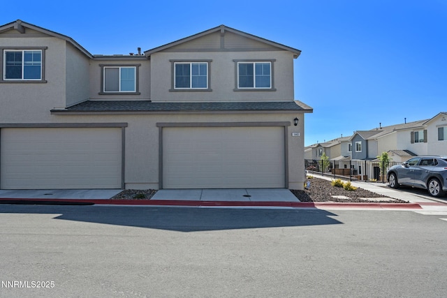 1440 Solitude Trl, Reno, NV 89523 - townhome / multi-family property with stucco siding, an attached garage, a residential view, and a shingled roof