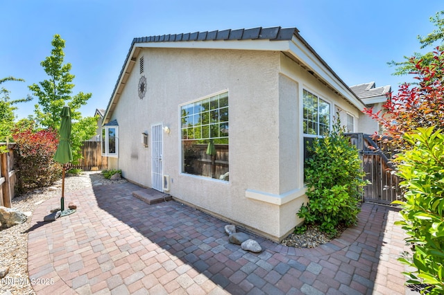 10559 Iron Point Cir, Reno, NV 89521 - back of house with stucco siding, a patio area, and a gate