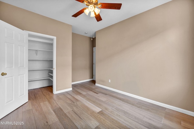 10559 Iron Point Cir, Reno, NV 89521 - unfurnished bedroom featuring wood finished floors, a spacious closet, a closet, and a ceiling fan