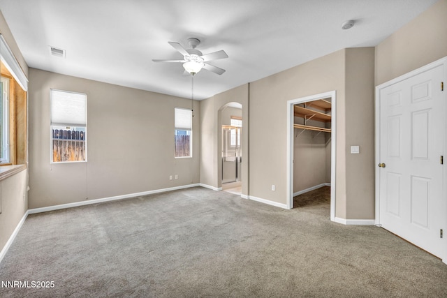 10559 Iron Point Cir, Reno, NV 89521 - unfurnished bedroom featuring arched walkways, carpet flooring, a spacious closet, a closet, and ensuite bathroom