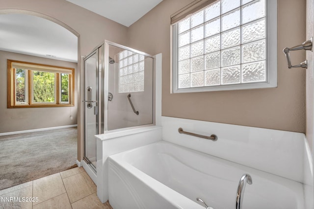 10559 Iron Point Cir, Reno, NV 89521 - bathroom with a garden tub, a shower stall, and tile patterned flooring