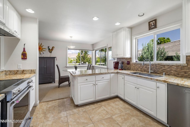 1435 Palisade Dr, Reno, NV 89509 - kitchen with a sink, appliances with stainless steel finishes, backsplash, a peninsula, and white cabinets