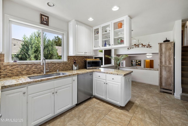 1435 Palisade Dr, Reno, NV 89509 - kitchen featuring a sink, appliances with stainless steel finishes, decorative backsplash, light stone counters, and glass insert cabinets