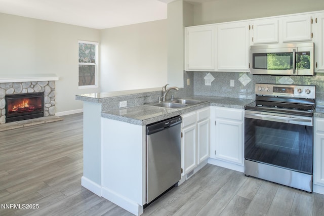4734 Tierrapark Ct, Reno, NV 89502 - kitchen with appliances with stainless steel finishes, light wood-style floors, and white cabinets