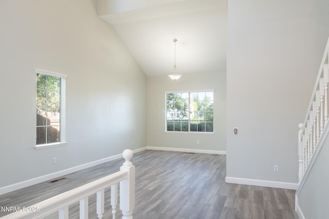 4734 Tierrapark Ct, Reno, NV 89502 - spare room with high vaulted ceiling, wood finished floors, and stairway