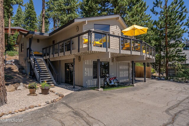 909 Tyner Way, Incline Village, NV 89451 - view of front of house featuring stairs, driveway, and a wooden deck