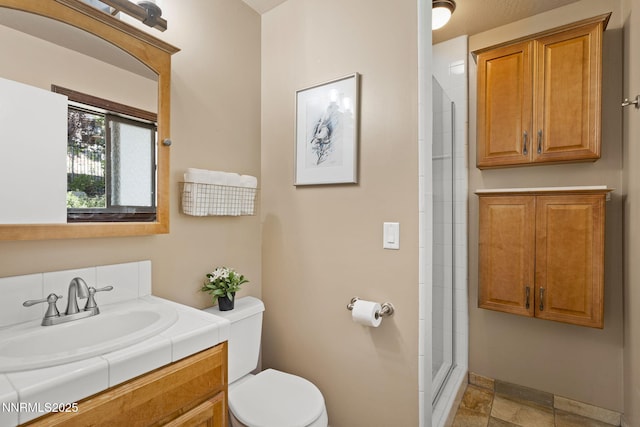 909 Tyner Way, Incline Village, NV 89451 - bathroom with toilet, vanity, a tile shower, stone finish floors, and baseboards