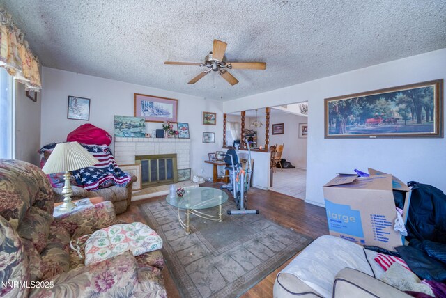 1650 Trabert Way, Sparks, NV 89431 - living area featuring ceiling fan, wood finished floors, a brick fireplace, and a textured ceiling
