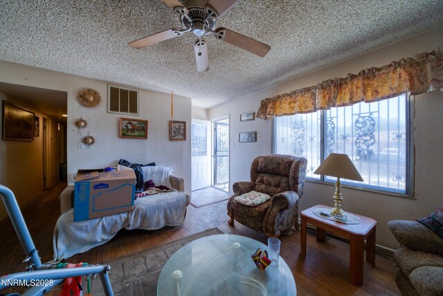 1650 Trabert Way, Sparks, NV 89431 - living area with wood finished floors, a textured ceiling, and a ceiling fan