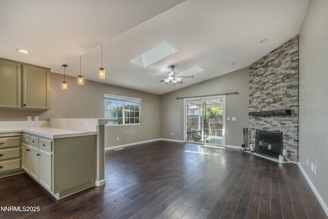 763 Canary Cir, Fernley, NV 89408 - kitchen featuring a skylight, open floor plan, a peninsula, light countertops, and healthy amount of natural light