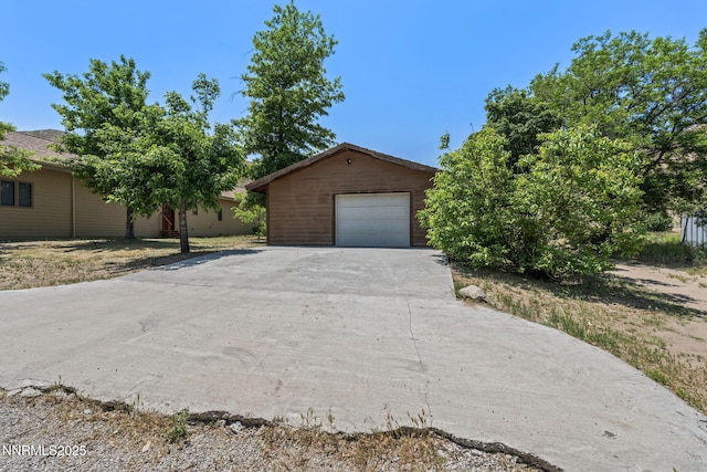105 Rodeo Dr, Reno, NV 89508 - view of front facade featuring driveway, an outbuilding, and a garage