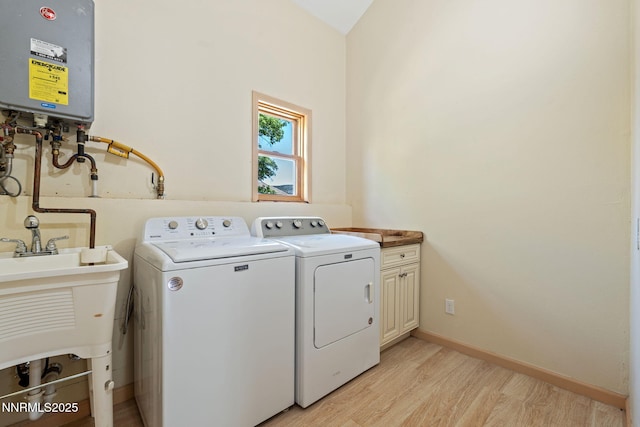 105 Rodeo Dr, Reno, NV 89508 - laundry area featuring cabinet space, separate washer and dryer, tankless water heater, light wood-style floors, and baseboards
