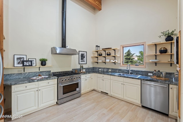 105 Rodeo Dr, Reno, NV 89508 - kitchen with stainless steel appliances, a sink, open shelves, light wood finished floors, and dark stone counters