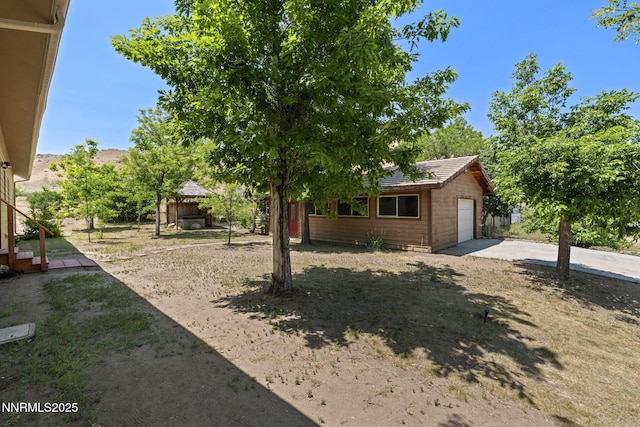 105 Rodeo Dr, Reno, NV 89508 - view of yard with a garage and concrete driveway