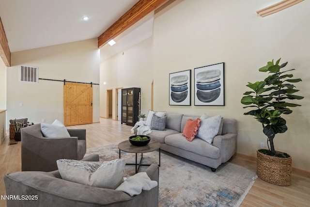105 Rodeo Dr, Reno, NV 89508 - living room with a barn door, wood finished floors, beamed ceiling, high vaulted ceiling, and baseboards