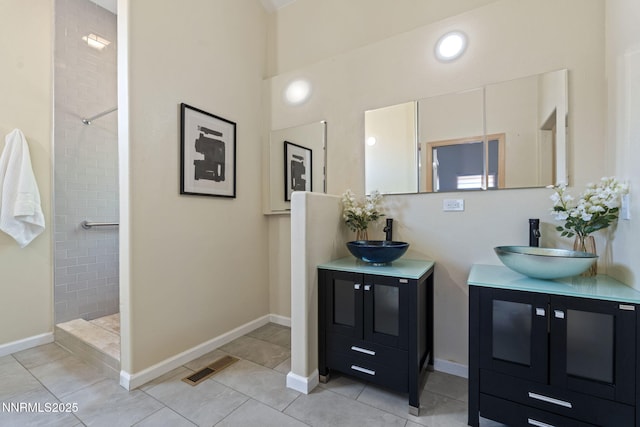 105 Rodeo Dr, Reno, NV 89508 - bathroom featuring tiled shower, two vanities, tile patterned floors, baseboards, and a high ceiling