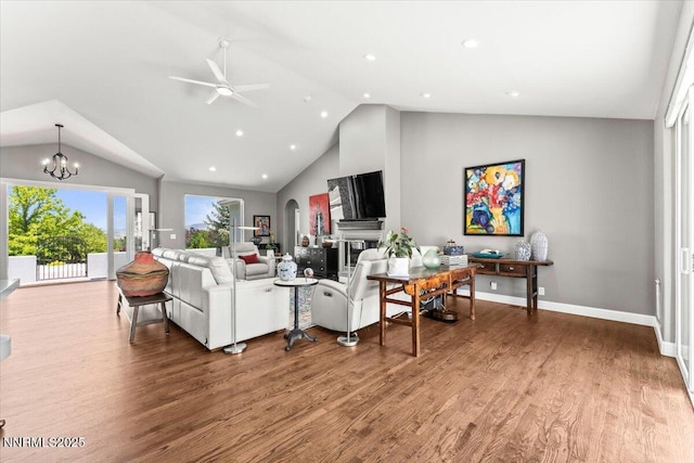 346 Wolf Run Ct, Reno, NV 89511 - living area with a ceiling fan, wood finished floors, a glass covered fireplace, a chandelier, and baseboards