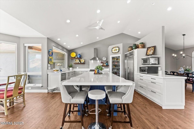 346 Wolf Run Ct, Reno, NV 89511 - kitchen with appliances with stainless steel finishes, open shelves, light countertops, a kitchen breakfast bar, and a chandelier