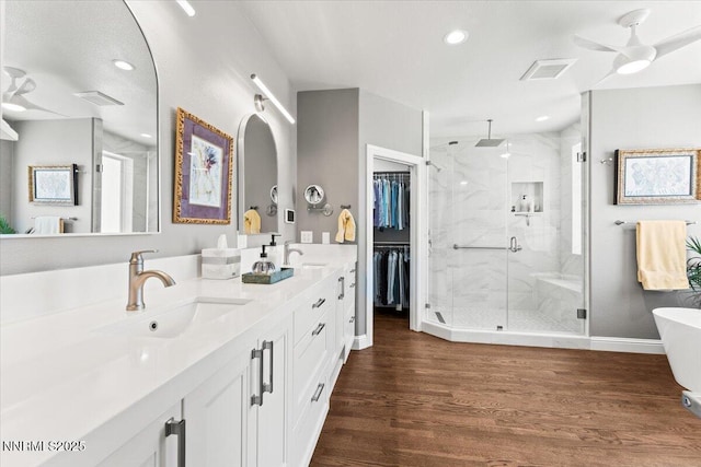 346 Wolf Run Ct, Reno, NV 89511 - bathroom with a marble finish shower, double vanity, wood finished floors, a freestanding bath, and baseboards