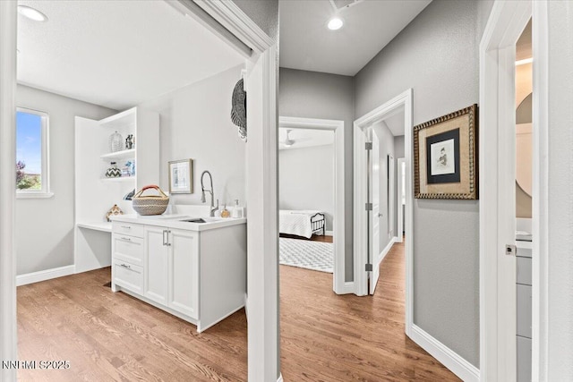 346 Wolf Run Ct, Reno, NV 89511 - hall with light wood-style flooring, a sink, and baseboards