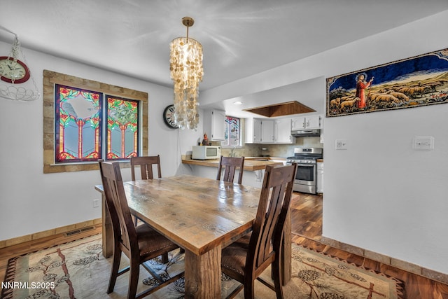 15333 Kivett Ln, Reno, NV 89521 - dining area with wood finished floors, baseboards, and a chandelier