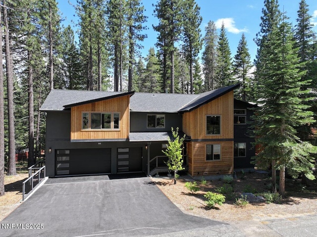 1877 Normuk St, South Lake Tahoe, CA 96150 - view of front of property with a garage, roof with shingles, and asphalt driveway