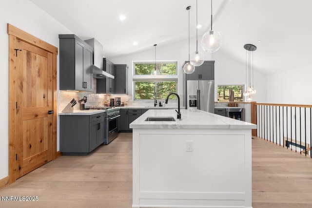 1877 Normuk St, South Lake Tahoe, CA 96150 - kitchen featuring appliances with stainless steel finishes, wall chimney exhaust hood, gray cabinets, vaulted ceiling, and a sink