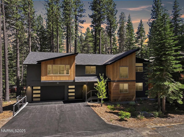 1877 Normuk St, South Lake Tahoe, CA 96150 - view of front of house featuring a shingled roof, an attached garage, and driveway