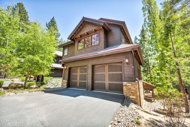886 Rosewood Cir, Incline Village, NV 89451 - view of side of property with asphalt driveway, stone siding, and an attached garage