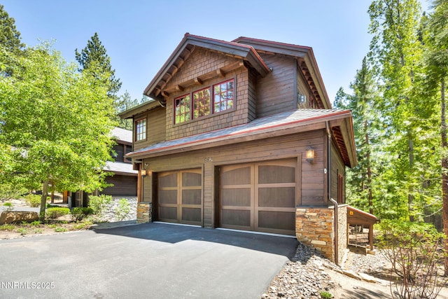 886 Rosewood Cir, Incline Village, NV 89451 - view of home's exterior with an attached garage, stone siding, and driveway