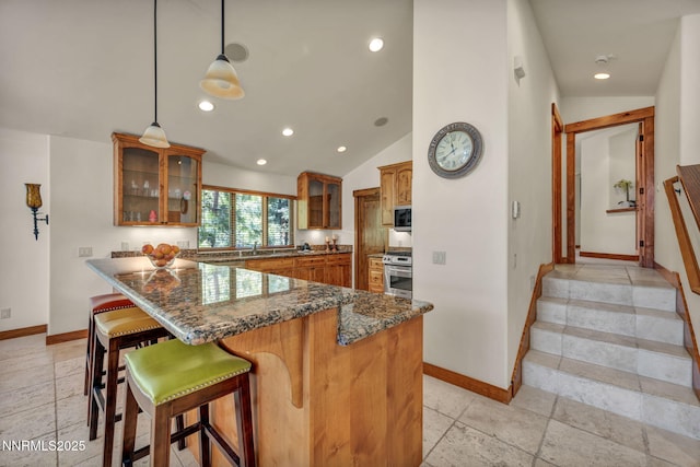 886 Rosewood Cir, Incline Village, NV 89451 - kitchen with baseboards, brown cabinetry, range, glass insert cabinets, and recessed lighting