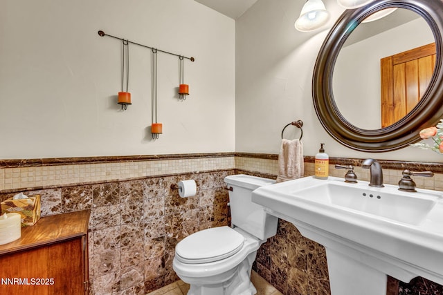 886 Rosewood Cir, Incline Village, NV 89451 - bathroom with tile walls, toilet, a wainscoted wall, and tile patterned floors