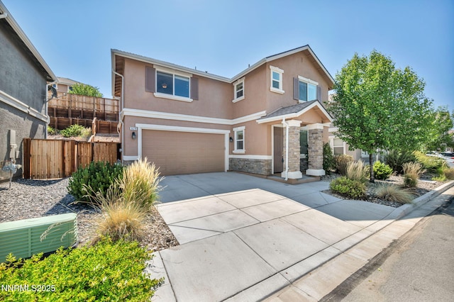 3678 Hollywood Park Dr, Reno, NV 89512 - view of front facade with stucco siding, stone siding, a garage, and driveway
