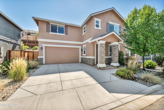 3678 Hollywood Park Dr, Reno, NV 89512 - view of front facade with stone siding, stucco siding, a garage, and concrete driveway