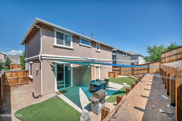 3678 Hollywood Park Dr, Reno, NV 89512 - rear view of property featuring a fenced backyard, a patio area, and stucco siding