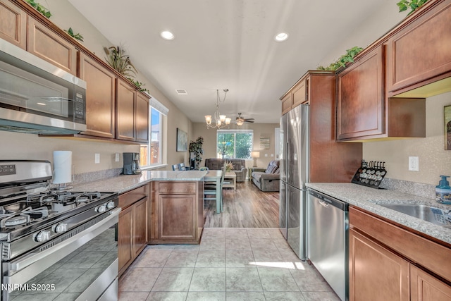 3678 Hollywood Park Dr, Reno, NV 89512 - kitchen with stainless steel appliances, a chandelier, open floor plan, recessed lighting, and a peninsula